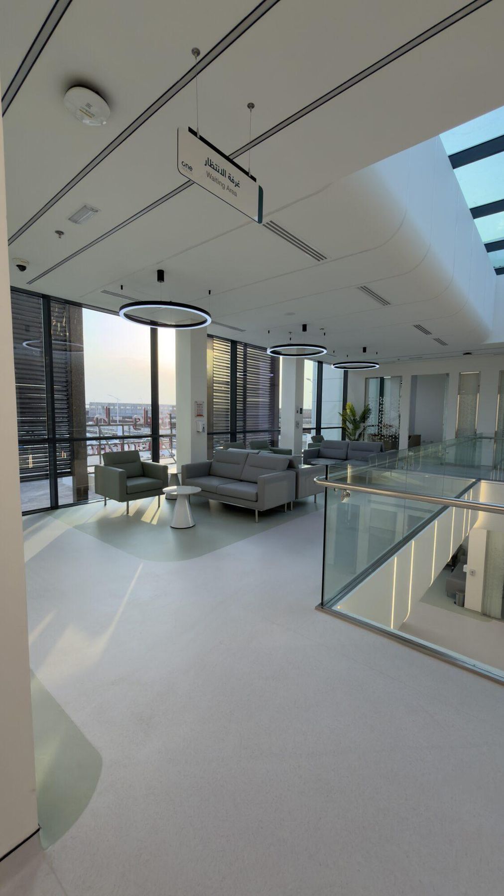 Upper-level lounge with floor-to-ceiling windows and seating