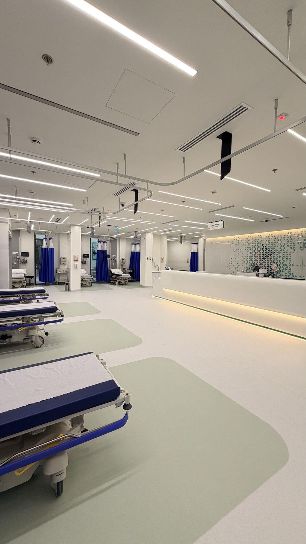 Urgent care treatment bays with stretchers and privacy curtains